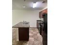 Functional kitchen features an island with a sink and black appliances at 2056 Belmont Cir, Conyers, GA 30012