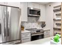 Modern kitchen features stainless steel appliances, a stylish backsplash, and ample cabinet space at 3201 Lenox Ne Rd # 23, Atlanta, GA 30324