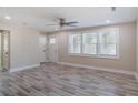 Bright living room with large windows, wood-look floors, neutral walls, and ceiling fan at 1256 Elizabeth Sw Ave, Atlanta, GA 30310