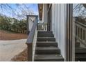 A view of the entryway steps leading to the house featuring neutral paint and a modern glass door at 353 Colchester Dr, Stone Mountain, GA 30088