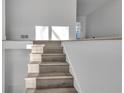 Bright interior staircase featuring wood-look treads, white risers and walls, and natural light at 353 Colchester Dr, Stone Mountain, GA 30088