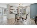 Bright dining area with a modern light fixture, large picture window, and neutral decor at 122 Belmonte Sw Dr, Atlanta, GA 30311