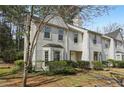 Charming townhouse with landscaped front yard, natural light, and inviting curb appeal at 122 Belmonte Sw Dr, Atlanta, GA 30311