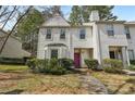 Inviting townhome featuring a pink front door, manicured landscaping, and a cozy exterior at 122 Belmonte Sw Dr, Atlanta, GA 30311
