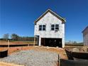 New construction home showing exterior framing details and wrapped for weather protection on a sunny day at 1227 Riverstone Rd, Jonesboro, GA 30238