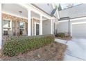 Inviting front porch with brick accents, white columns, and seating area at 1874 Manor View Nw Cir # 4, Acworth, GA 30101