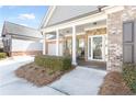 Charming front porch with white columns, brick accents, and seating at 1874 Manor View Nw Cir # 4, Acworth, GA 30101