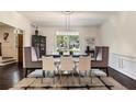 Bright dining room featuring stylish chairs, contemporary lighting, and large windows at 3391 Pinestream Nw Rd, Atlanta, GA 30327