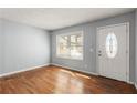 Inviting living room with beautiful wood floors, a large window, and a neutral color palette at 866 United Se Ave, Atlanta, GA 30312