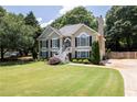 Charming two-story home featuring black shutters, a manicured lawn and inviting front entrance and manicured yard at 2515 Little John Ct, Cumming, GA 30040