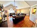 Bright living area featuring hardwood floors, a fireplace, and comfortable leather seating at 2515 Little John Ct, Cumming, GA 30040