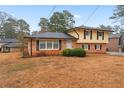 Charming two-story home featuring brick and siding, black shutters, and a well-kept lawn at 2002 Twin Falls Rd, Decatur, GA 30032