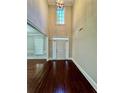 Grand foyer with high ceilings, hardwood floors, and a large window for natural light at 2822 Salem Oak Way, Duluth, GA 30096