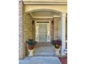 Inviting front entrance with brick porch, flanked by planters and classic door at 2822 Salem Oak Way, Duluth, GA 30096