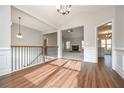 Entryway of a home with wood floors, chandelier, staircase and an open view of the living room at 5995 Crowley Dr, Douglasville, GA 30135