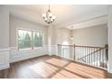Bright room boasting wood-look floors, wainscoting, and a large window providing ample natural light at 5995 Crowley Dr, Douglasville, GA 30135
