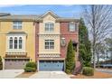 Attractive brick townhome showcasing a private garage and well-maintained landscaping at 928 Boudreau Ct, Atlanta, GA 30328