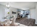 Eat-in kitchen with stainless steel appliances, light blue cabinets and hardwood floors at 63 Colette Ct, Douglasville, GA 30134