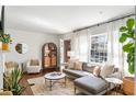 Sun-filled living room featuring hardwood floors, a cozy sectional, and modern decor at 1328 Briarwood Ne Dr, Atlanta, GA 30306