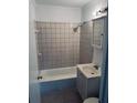 A full bathroom with a tiled shower-tub and built in vanity at 3095 Rainbow Dr, Decatur, GA 30034