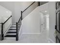 Elegant foyer with staircase featuring modern black railings and marble floors, offering a grand entrance at 3521 Kittery Dr, Snellville, GA 30039