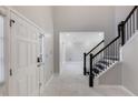 Bright foyer features white marble floors and stairway with black railings at 3521 Kittery Dr, Snellville, GA 30039