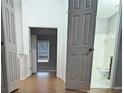 Hallway with hardwood floors connecting bedrooms and bathroom, providing easy access and a seamless flow at 3958 Wolcott Cir, Doraville, GA 30340