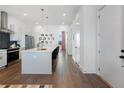 Bright kitchen with stainless steel appliances, center island with seating, and luxury vinyl plank flooring at 989 Bibbs Circle Nw, Atlanta, GA 30318