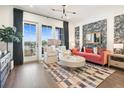 Staged living room featuring large windows, patterned wallpaper, modern furniture and luxury vinyl plank flooring at 989 Bibbs Circle Nw, Atlanta, GA 30318