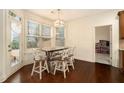 Cozy breakfast nook featuring a modern light fixture, ample natural light, and stylish barstool seating for casual dining at , Atlanta, GA 30318