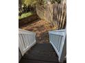 View from the top of back stairs leading down to a fenced yard at 234 Carlyle Park Ne Dr # 234, Atlanta, GA 30307