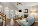 Inviting living room showcasing hardwood floors, a brick fireplace, and a vaulted ceiling for an open feel at 302 Roswell Green Ln, Roswell, GA 30075
