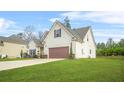 A two-story home featuring a well-manicured lawn, attached garage, and classic suburban architecture at 6441 Oakhurst Pl, Fairburn, GA 30213