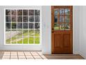 Bright entryway featuring a wood door, natural light from the window, and light-colored flooring at 8212 Englewood Trl, Riverdale, GA 30274