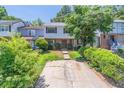 Quaint two-story townhome with a concrete driveway and landscaping, offering a serene suburban setting at 2090 Sand Wedge Nw Cir, Kennesaw, GA 30144