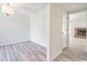Bright living room showcases new floors, fresh paint, and inviting open floor plan to a brick fireplace at 2090 Sand Wedge Nw Cir, Kennesaw, GA 30144