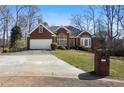 Beautiful brick home featuring a manicured lawn and a convenient two-car garage at 1129 Annie Sw Ln, Mableton, GA 30126