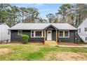 Charming home featuring a dark brick exterior, inviting front porch, and well-maintained lawn at 1282 Westridge Sw Rd, Atlanta, GA 30311