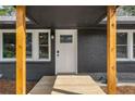 Inviting front porch with natural wood accents and updated black brick exterior at 1282 Westridge Sw Rd, Atlanta, GA 30311