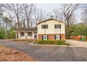 Inviting two-story home with dark shutters and a cozy front porch with seating at 1417 Hickory Sw Dr, Lilburn, GA 30047