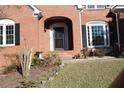 Arched front entrance with black front door and manicured landscaping at 2335 Corbett Ct, Powder Springs, GA 30127