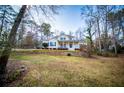 Beautiful home with large front yard, complimented by mature trees at 7364 N Mitchell N Ct, Villa Rica, GA 30180