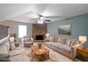 Cozy living room with stone fireplace, neutral furniture, and plenty of natural light at 1946 Taffeta Trl, Lithonia, GA 30058
