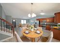 Bright, open-concept living and dining area features modern decor and staircase at 1946 Taffeta Trl, Lithonia, GA 30058