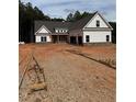 New construction home with white siding, brick accents, and an attached two car garage at 215 Pinewood Dr, Covington, GA 30014