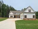 Lovely new construction farmhouse with a three car garage, nice lawn and professional landscaping at 215 Pinewood Dr, Covington, GA 30014