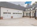 Spacious three-car garage featuring white doors and black hardware with convenient access to the home at 215 Pinewood Dr, Covington, GA 30014