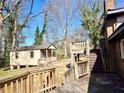 Backyard view featuring a deck, exterior stairs, a storage shed and a glimpse of the surrounding landscape at 2348 Jones Nw Rd, Atlanta, GA 30318