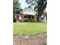 Charming home with a well-manicured lawn and inviting front porch at 1670 Rogers Sw Ave, Atlanta, GA 30310