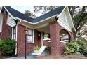 Charming brick home with landscaped front yard, lamp post, and inviting front porch at 1670 Rogers Sw Ave, Atlanta, GA 30310